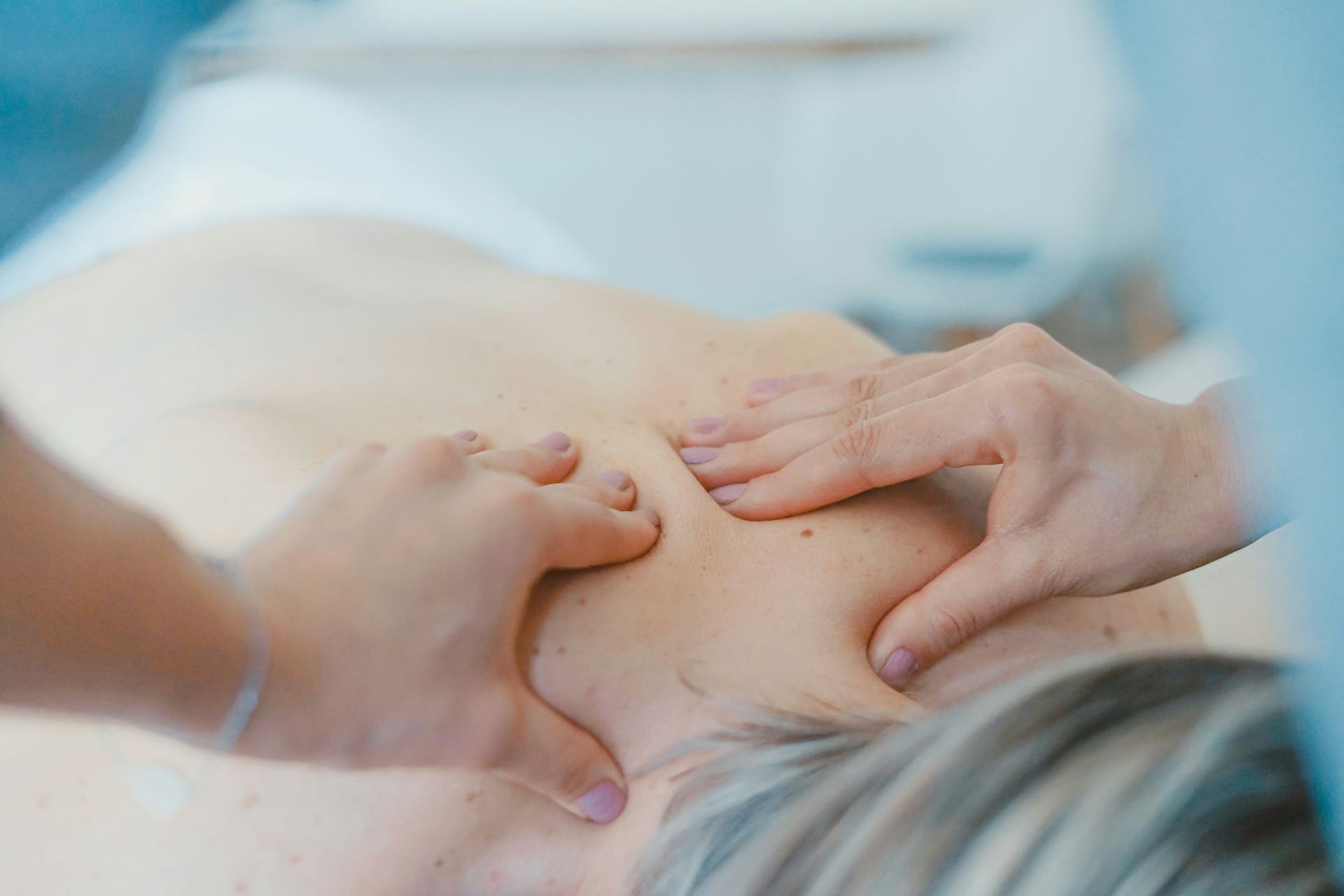 Hands massaging a back