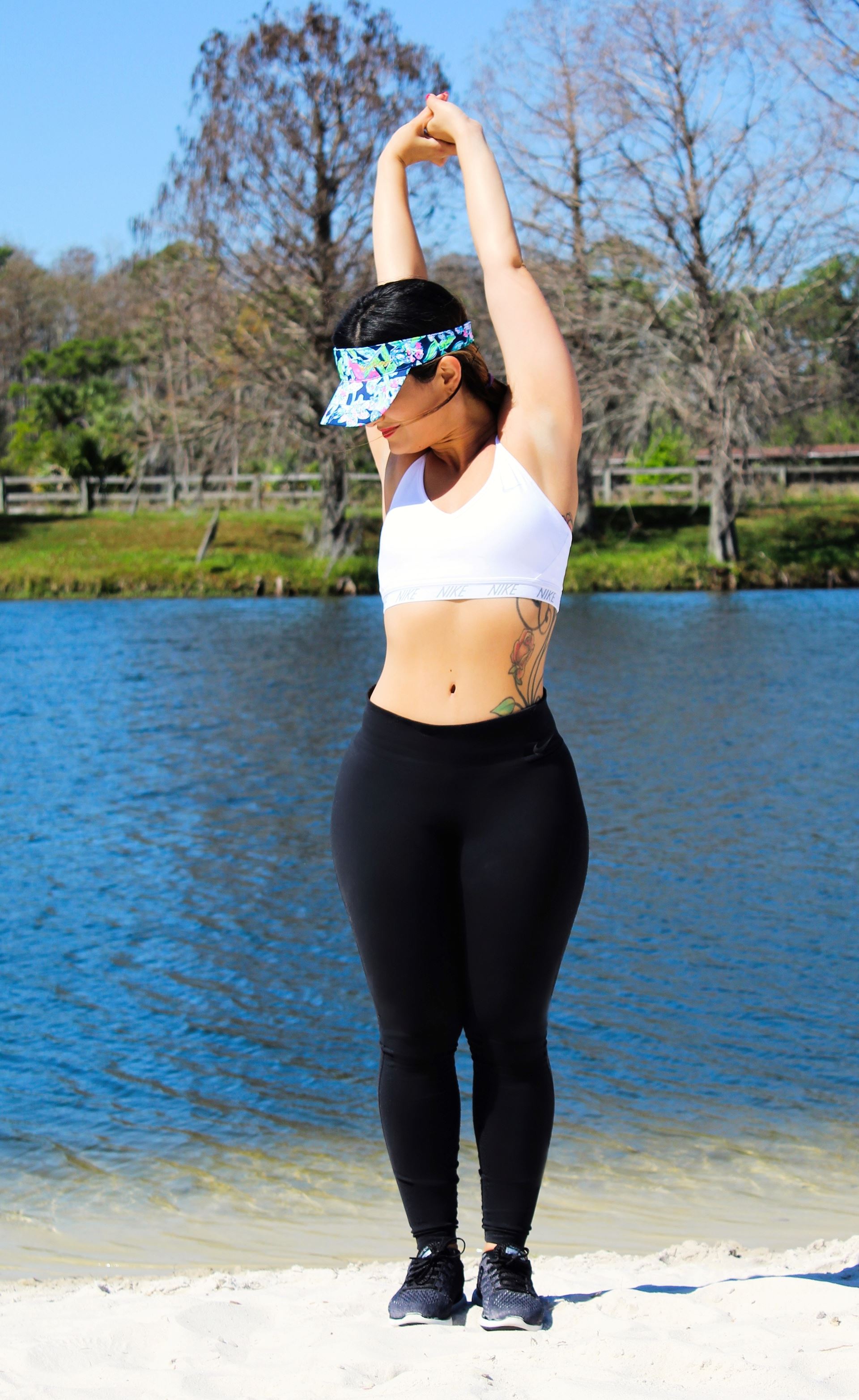 a woman standing next to a body of water